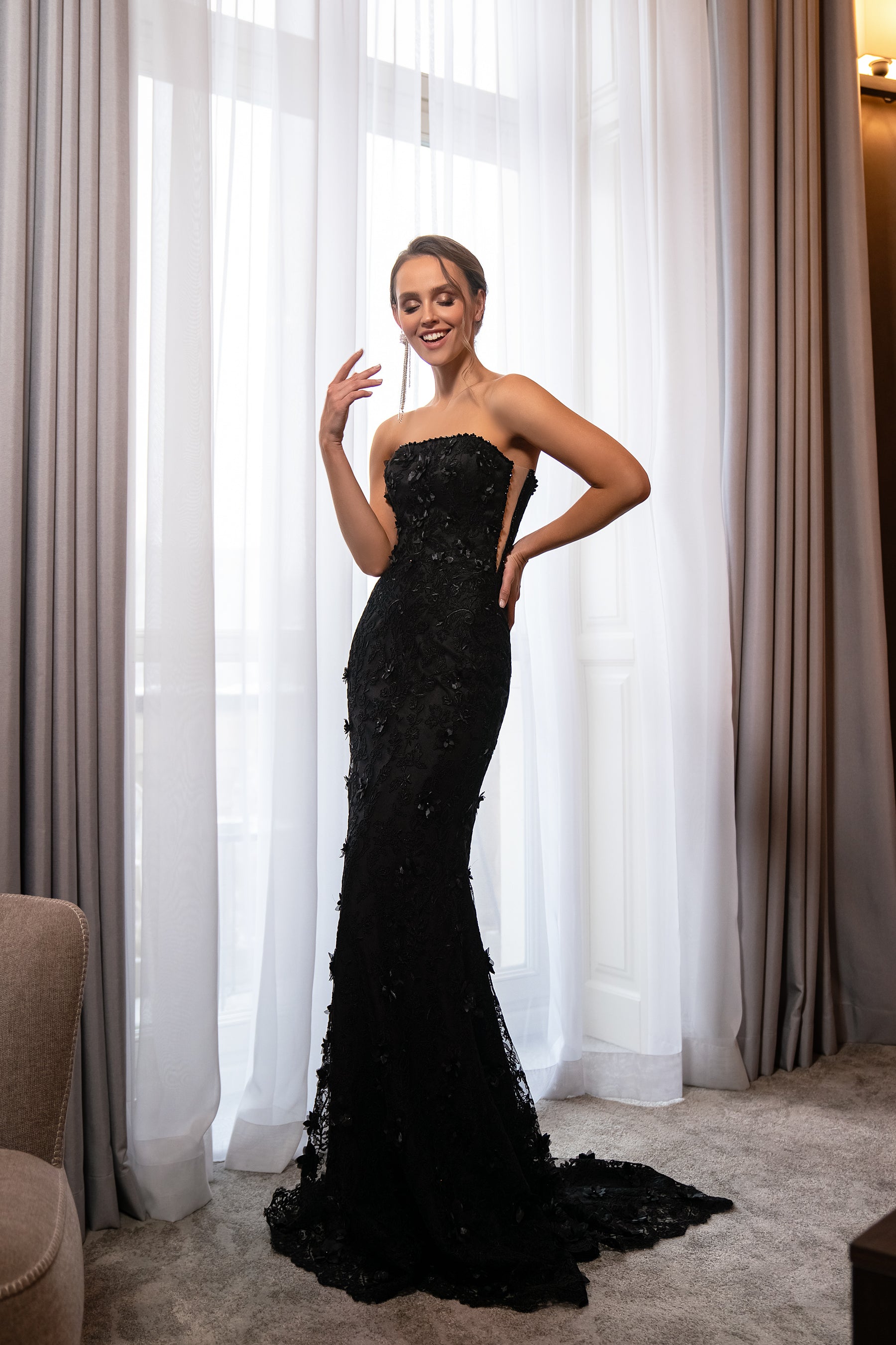 Black strapless mermaid evening dress with a fitted silhouette, embellished texture, and sweeping train