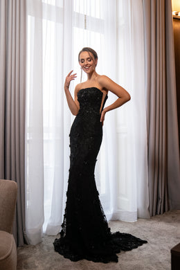 Black strapless mermaid evening dress with a fitted silhouette, embellished texture, and sweeping train