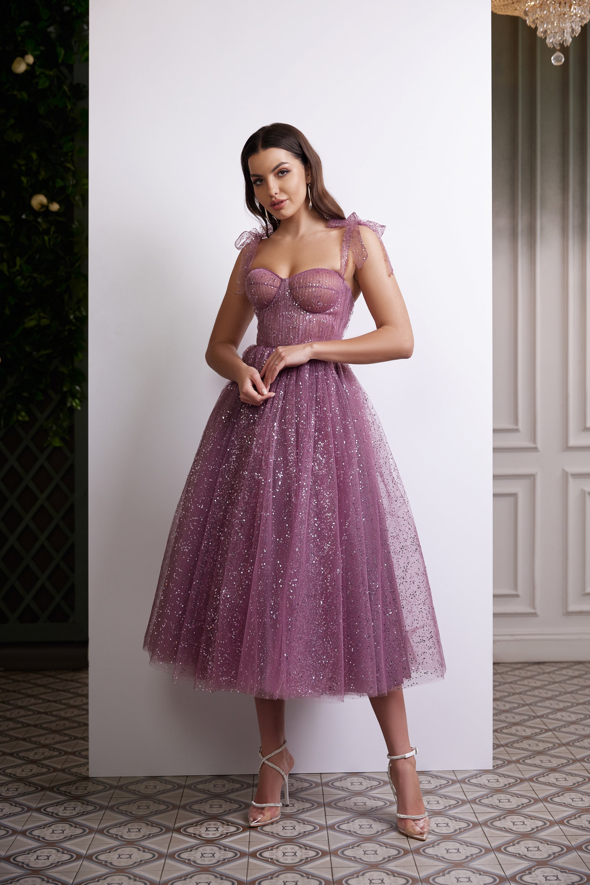 Purple sequined evening dress with a sweetheart bodice, sheer tulle straps, and a full tea-length skirt