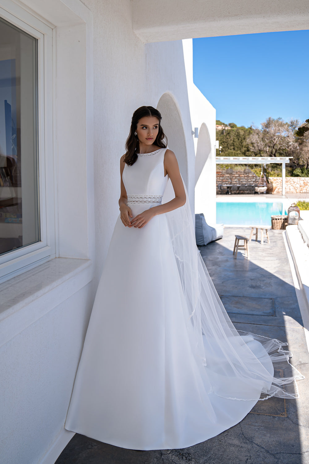 Romantic Minimalist Wedding Dress with Boat Neck, Tulle Inserts, Boho Lace, and Flared Skirt with Train and Pockets.