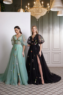 Black evening dress with sheer puff sleeves, floral embroidery, and a high thigh slit