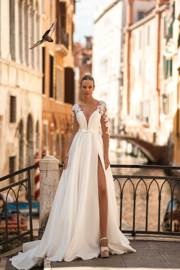 Elegant A-Line Wedding Gown with Deep V-Neck, Low Back, Long Lace Sleeves, Bow at Waist, and Slit Skirt