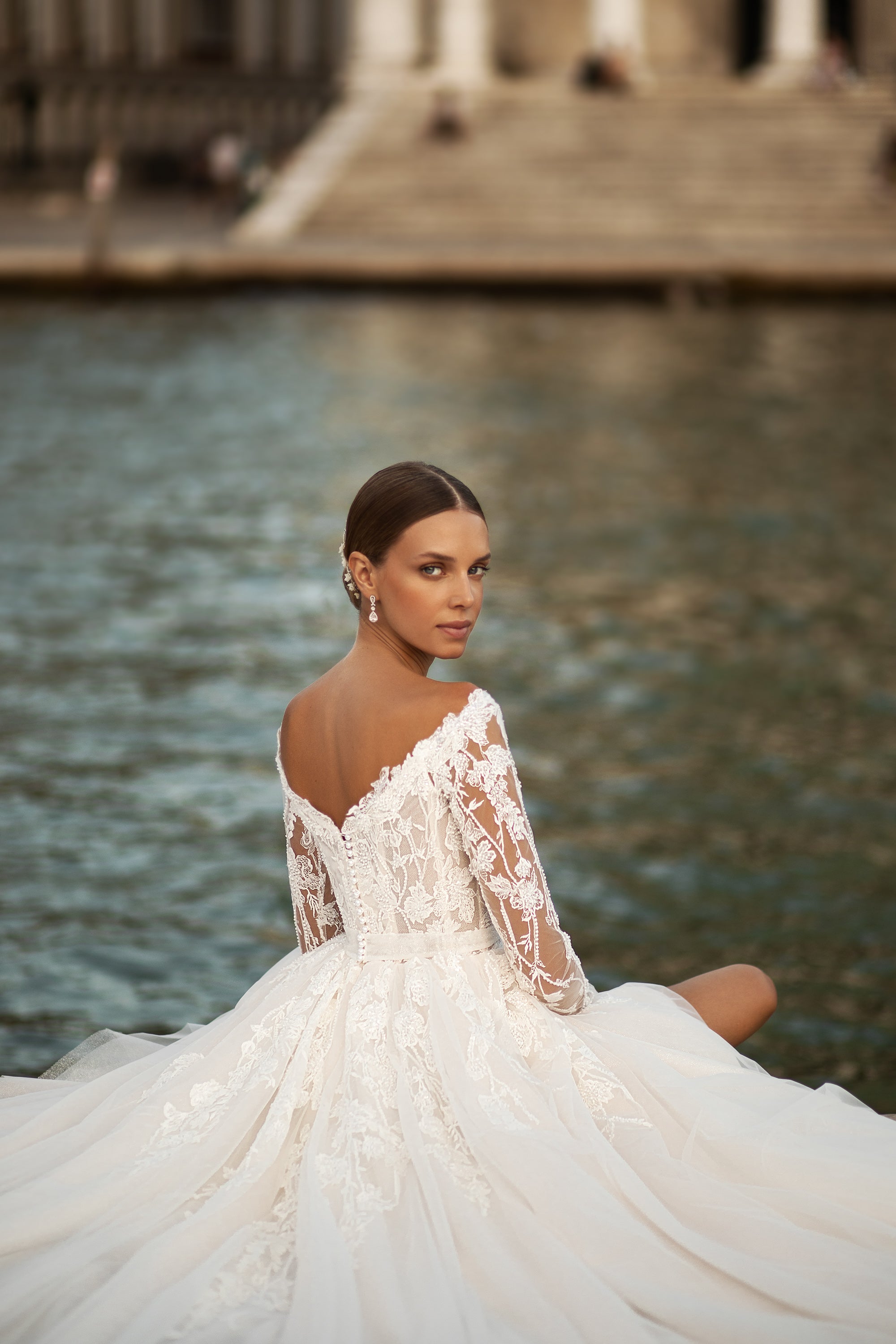 Elegant A-Line Wedding Gown with Tulle Skirt, Small Bow at Waist, Long Sleeves with Lace, Buttons Back, and Court Train