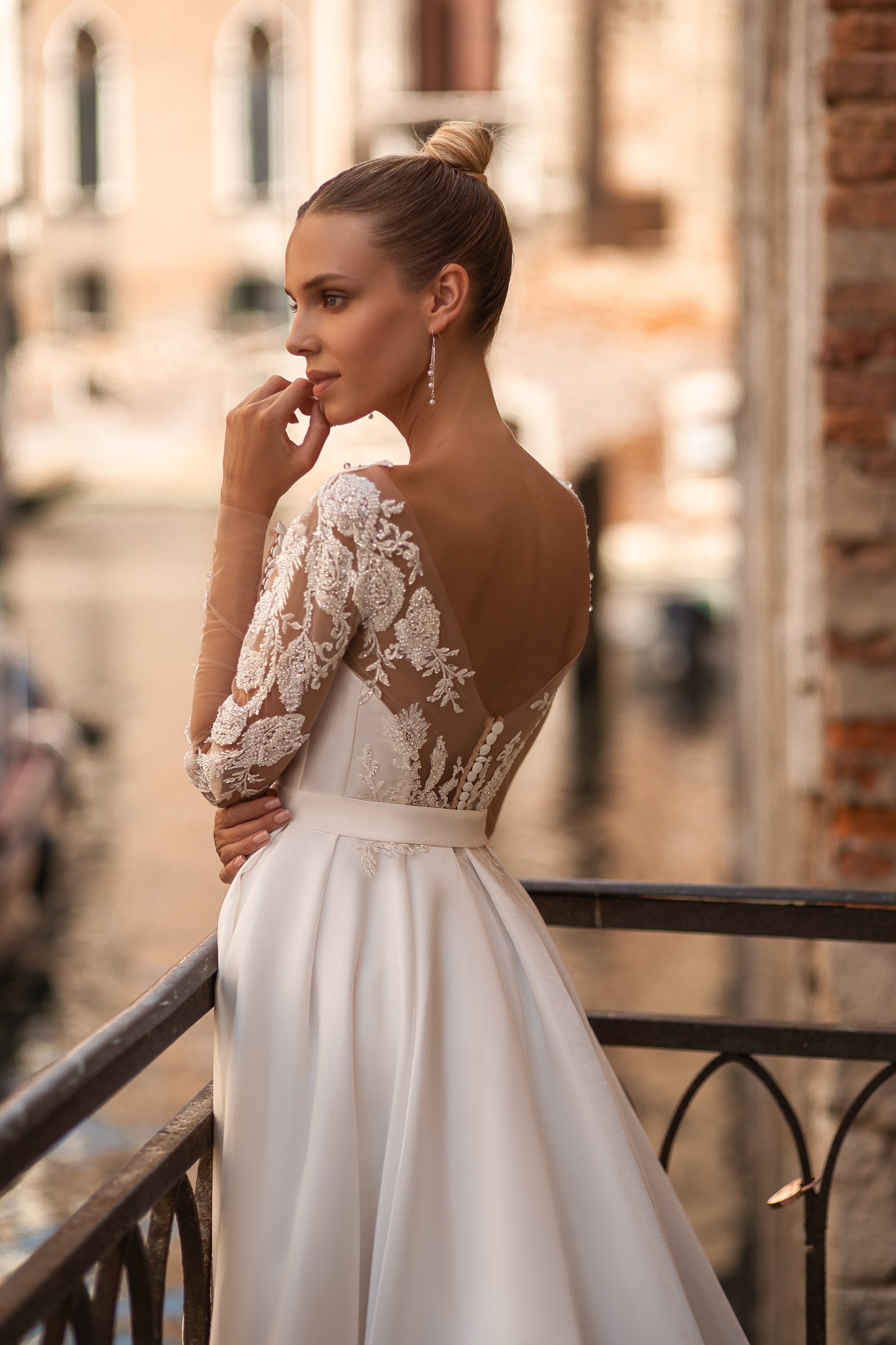 Elegant A-Line Wedding Gown with Deep V-Neck, Low Back, Long Lace Sleeves, Bow at Waist, and Slit Skirt