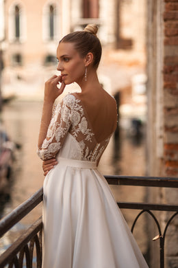 Elegant A-Line Wedding Gown with Deep V-Neck, Low Back, Long Lace Sleeves, Bow at Waist, and Slit Skirt