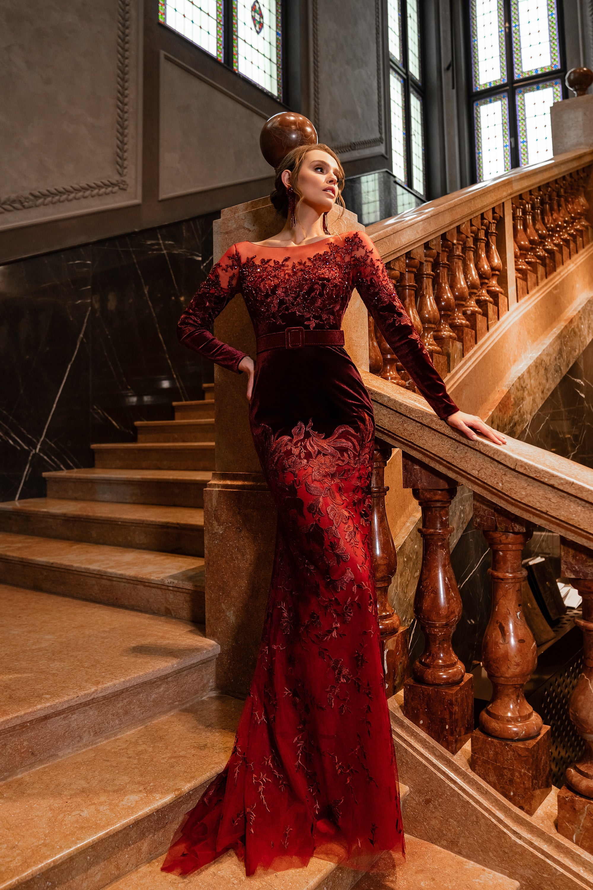 Burgundy evening dress with long sleeves, boat neckline, fitted mermaid silhouette, and floral detailing