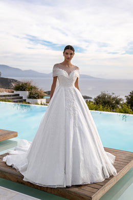 White ball gown wedding dress with illusion neckline, off-shoulder sleeves, sparkling lace, and a wide skirt