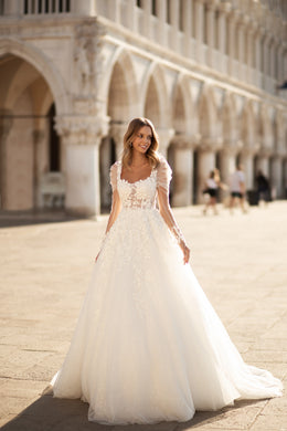 Ivory A-line wedding dress with floral lace bodice, short lace sleeves, and a full train