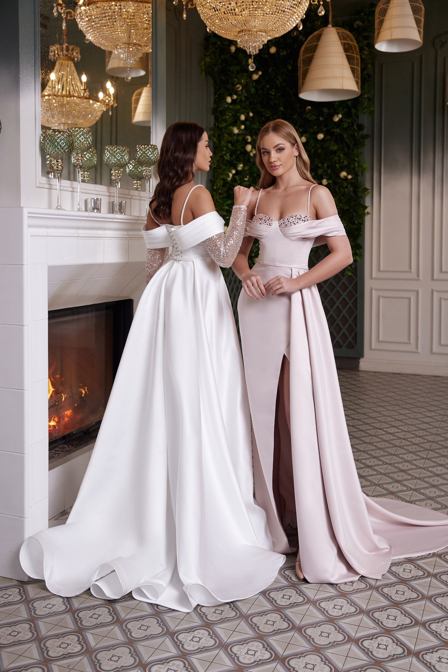 Back of a white evening dress with thin straps, an off-shoulder band, fitted waist, and sweeping train