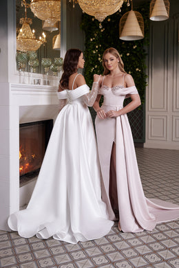 Back of a white evening dress with thin straps, an off-shoulder band, fitted waist, and sweeping train