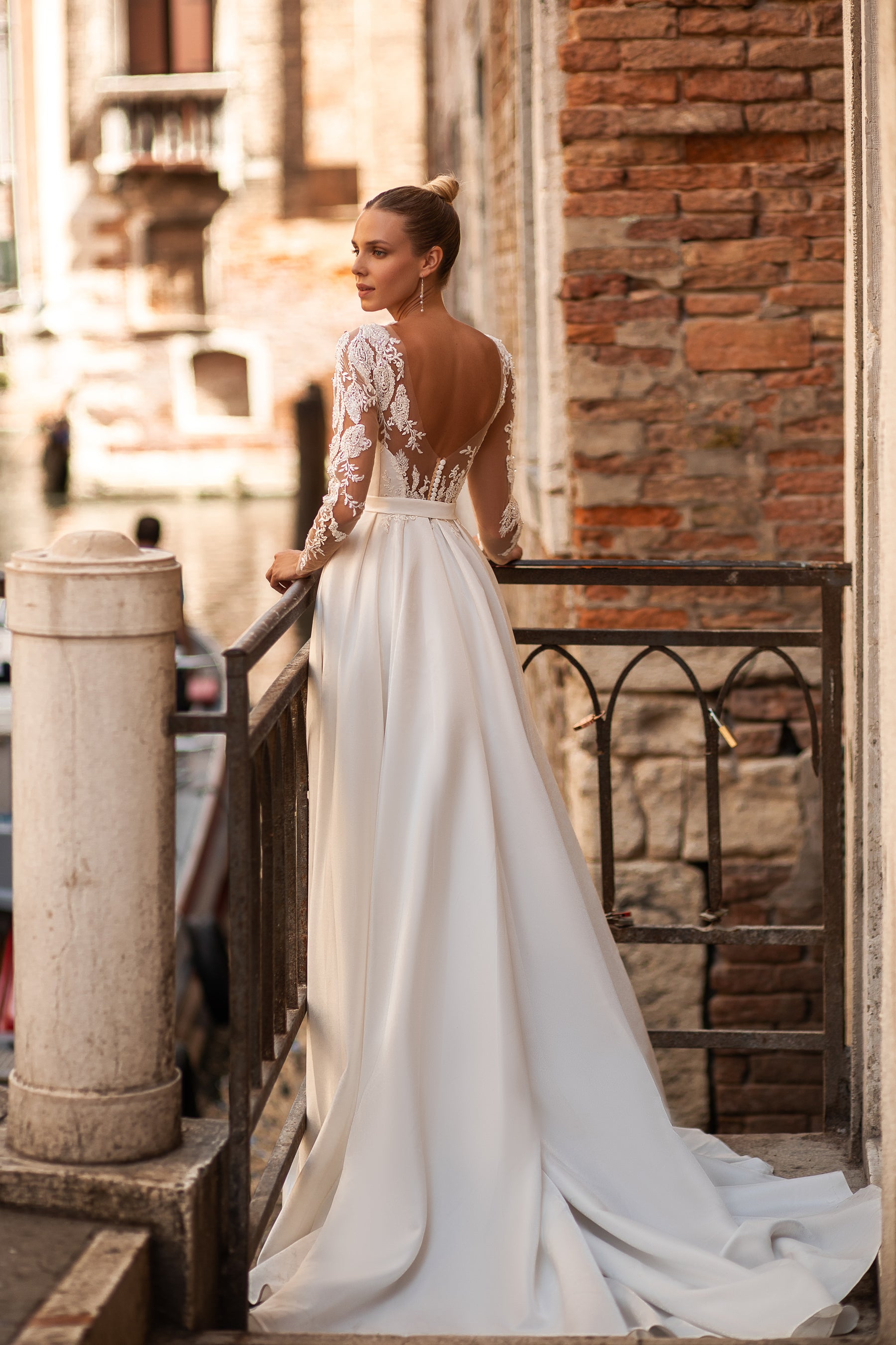 Elegant A-Line Wedding Gown with Deep V-Neck, Low Back, Long Lace Sleeves, Bow at Waist, and Slit Skirt