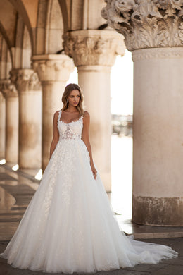 Full ivory A-line wedding dress with a floral lace bodice, sleeveless design, and sweeping train