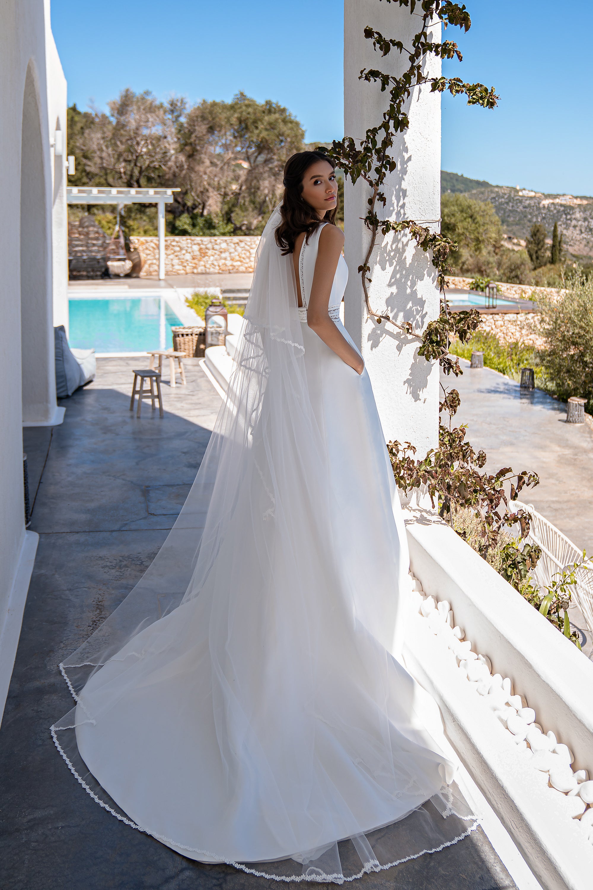 Romantic Minimalist Wedding Dress with Boat Neck, Tulle Inserts, Boho Lace, and Flared Skirt with Train and Pockets.