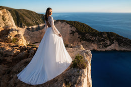 Beautiful Boho Wedding Dress with Embroidered Sequins, Lace, Long Sleeves, Corset, and Deep Cut Back