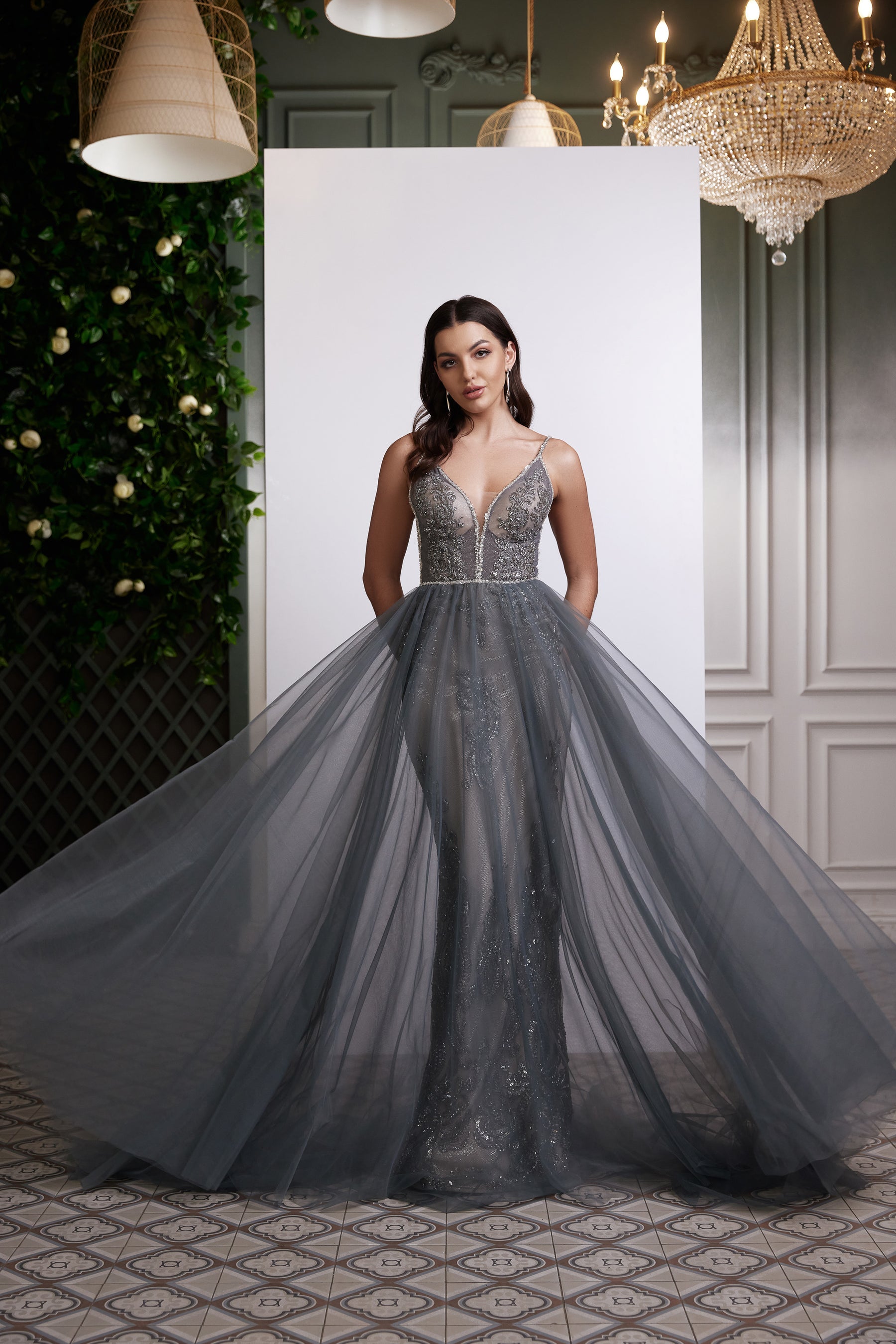 Silver-gray evening dress with spaghetti straps, plunging V-neck, beaded bodice, and glittering full skirt
