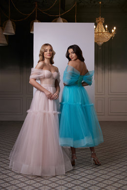 Blush pink evening dress featuring a fitted bodice, off-the-shoulder sleeves, and a flowing full tulle skirt