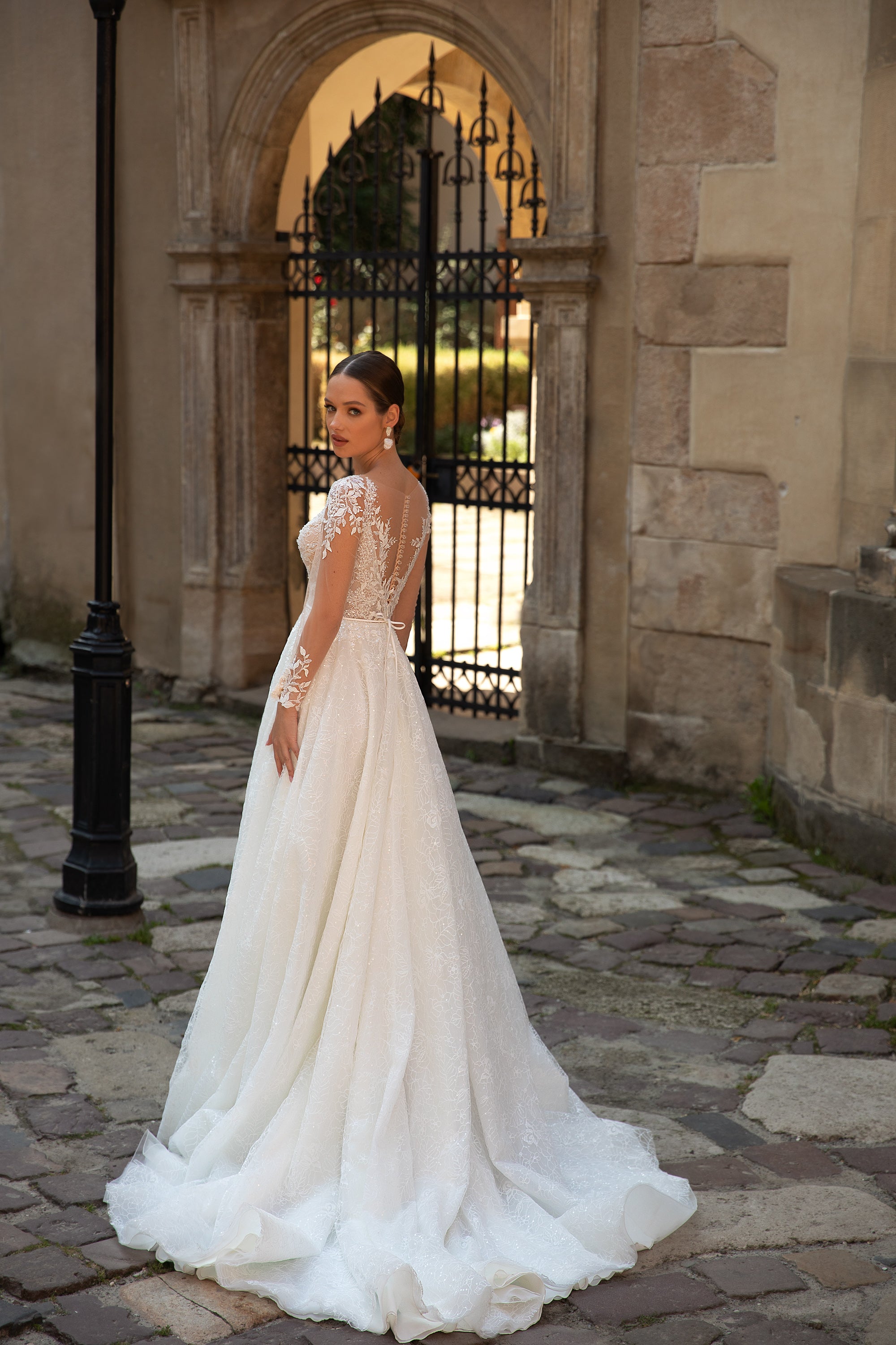 Elegant A-Line Wedding Gown with Slit Skirt, Lace, Buttons Back, and Long Sleeve Lace