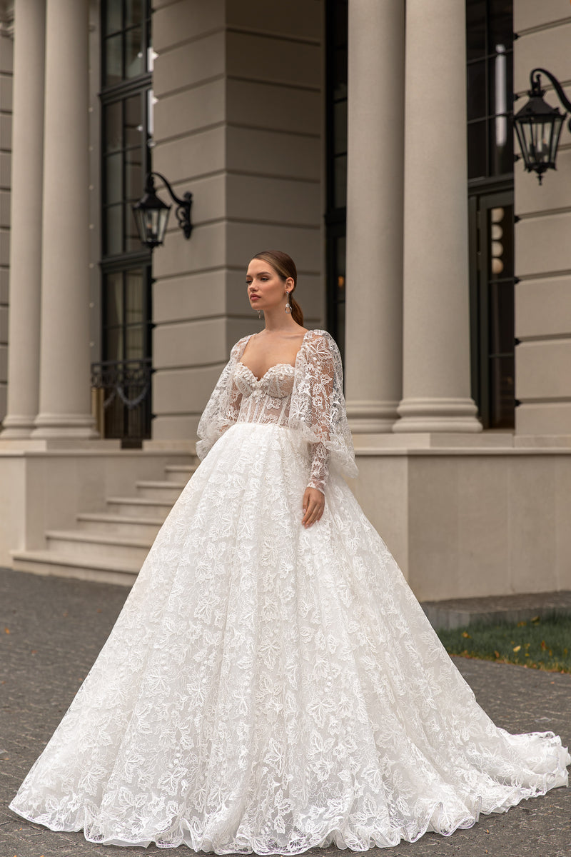Ivory ball gown wedding dress with long floral lace sleeves, sweetheart neckline, and full sweeping skirt