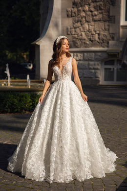Ivory ball gown wedding dress with floral lace, plunging V-neckline, and wide flowing skirt